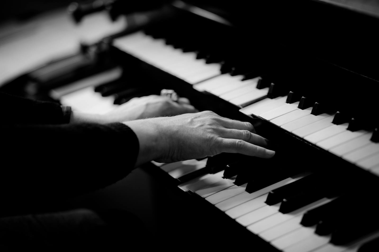 Close-up of hands playing piano keys, capturing the essence of musical creativity.