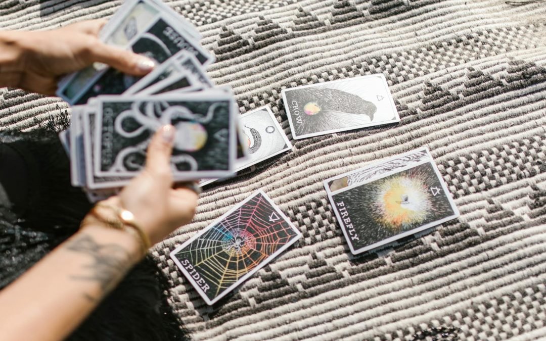 Hands dealing tarot cards for a reading on a stylish geometric rug.