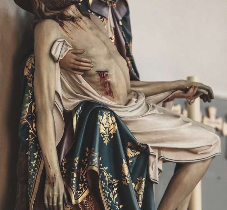 Mary cradles the dead jesus in her arms.