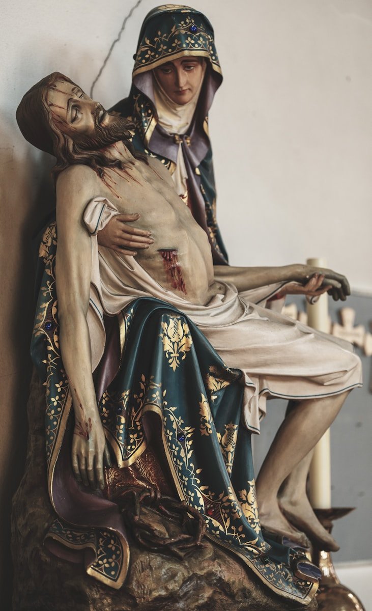 Mary cradles the dead jesus in her arms.