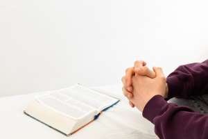 a person sitting at a table with an open book