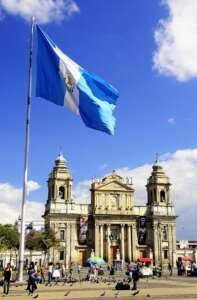 white and blue flag on pole